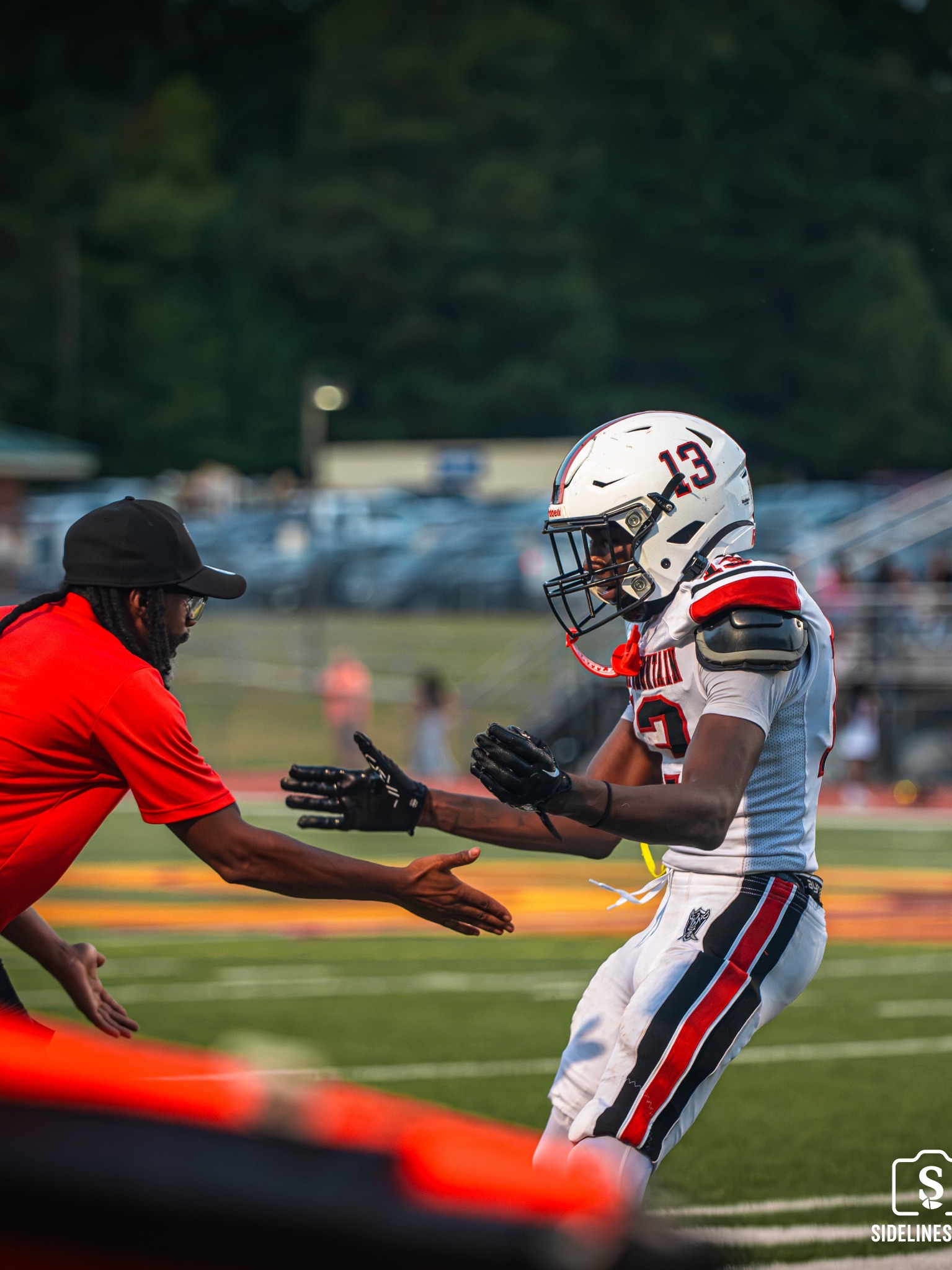Stone Mountain player greeting a coach